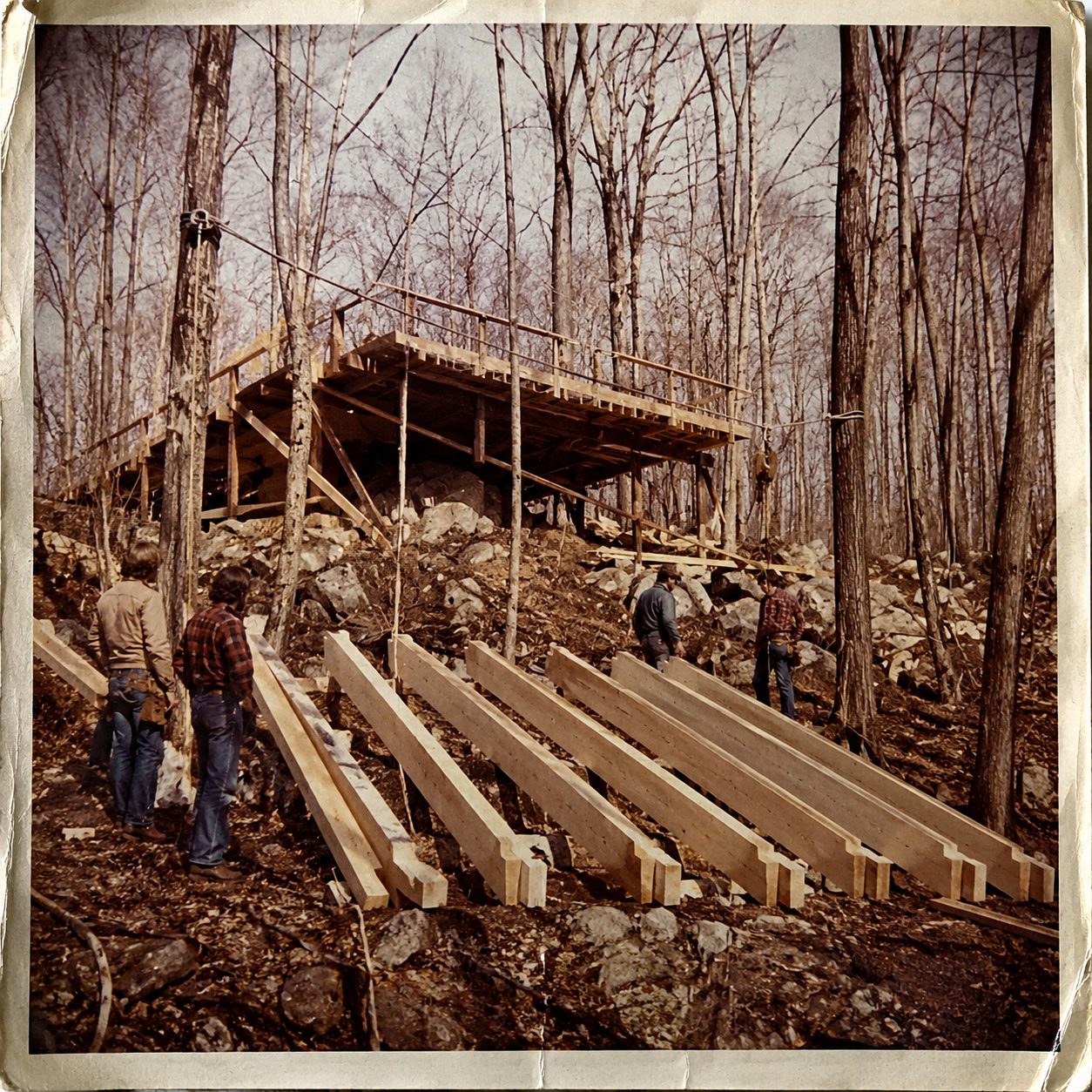 1970s photograph of beams laid out on the building platform