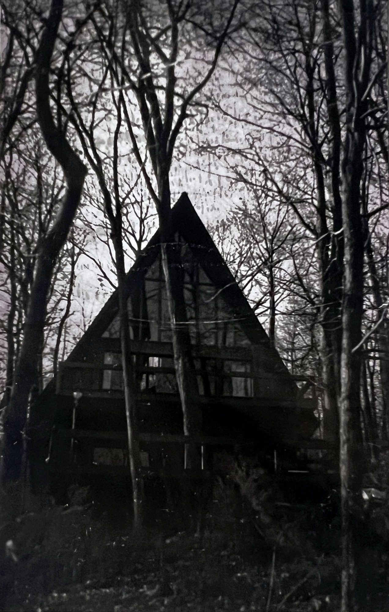 Black and white photograph of the A-frame in winter woods