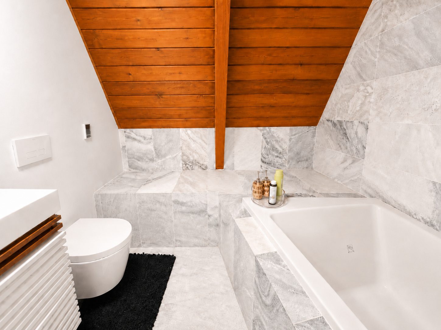 Marble main bath with soaking tub under a cedar ceiling