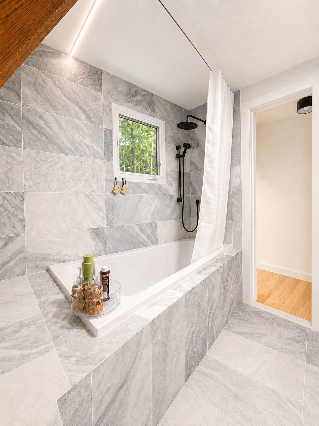 Marble main bathroom with soaking tub and skylit shower
