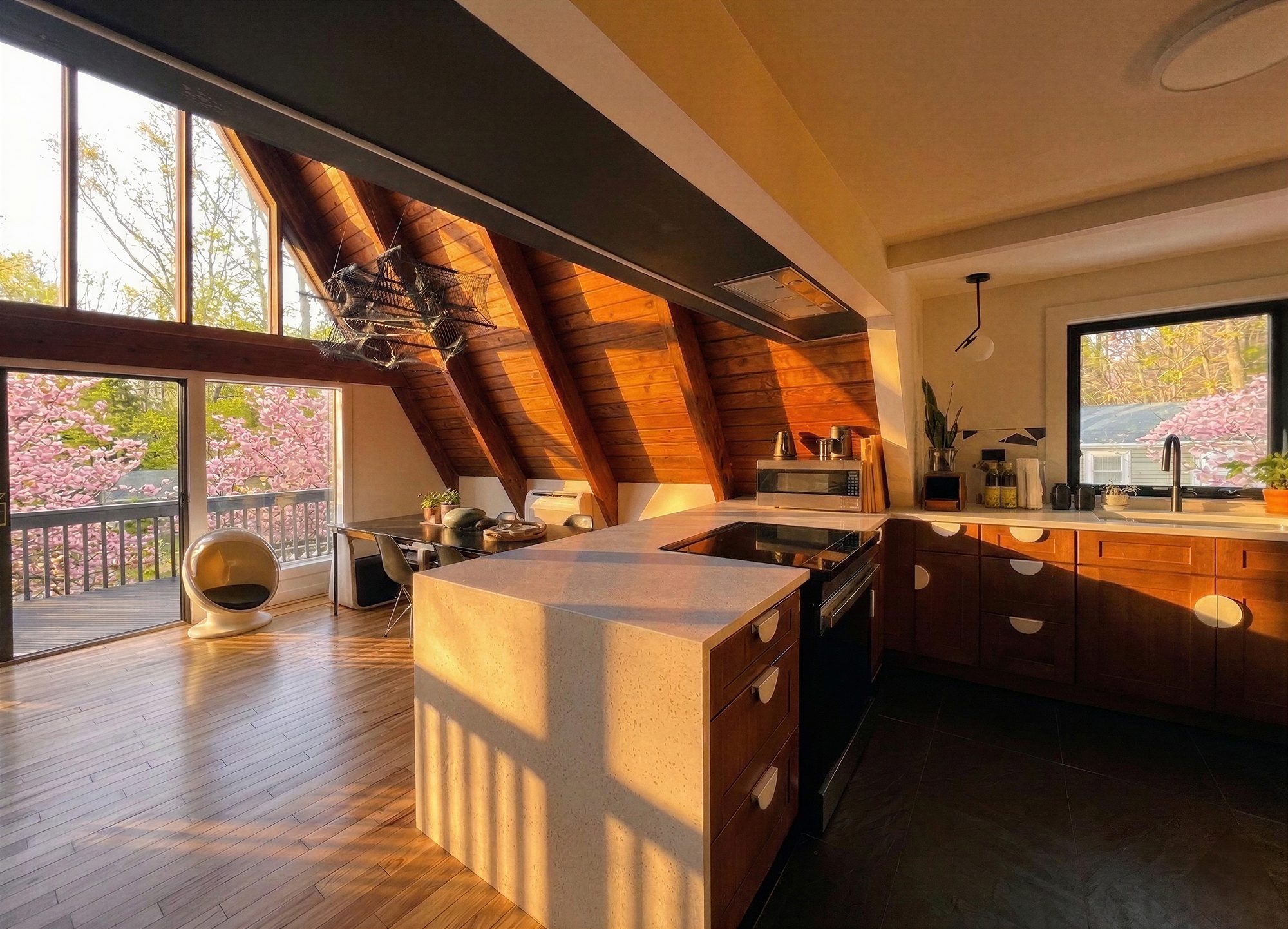 Sunlit kitchen island with white counters and warm wood cabinets