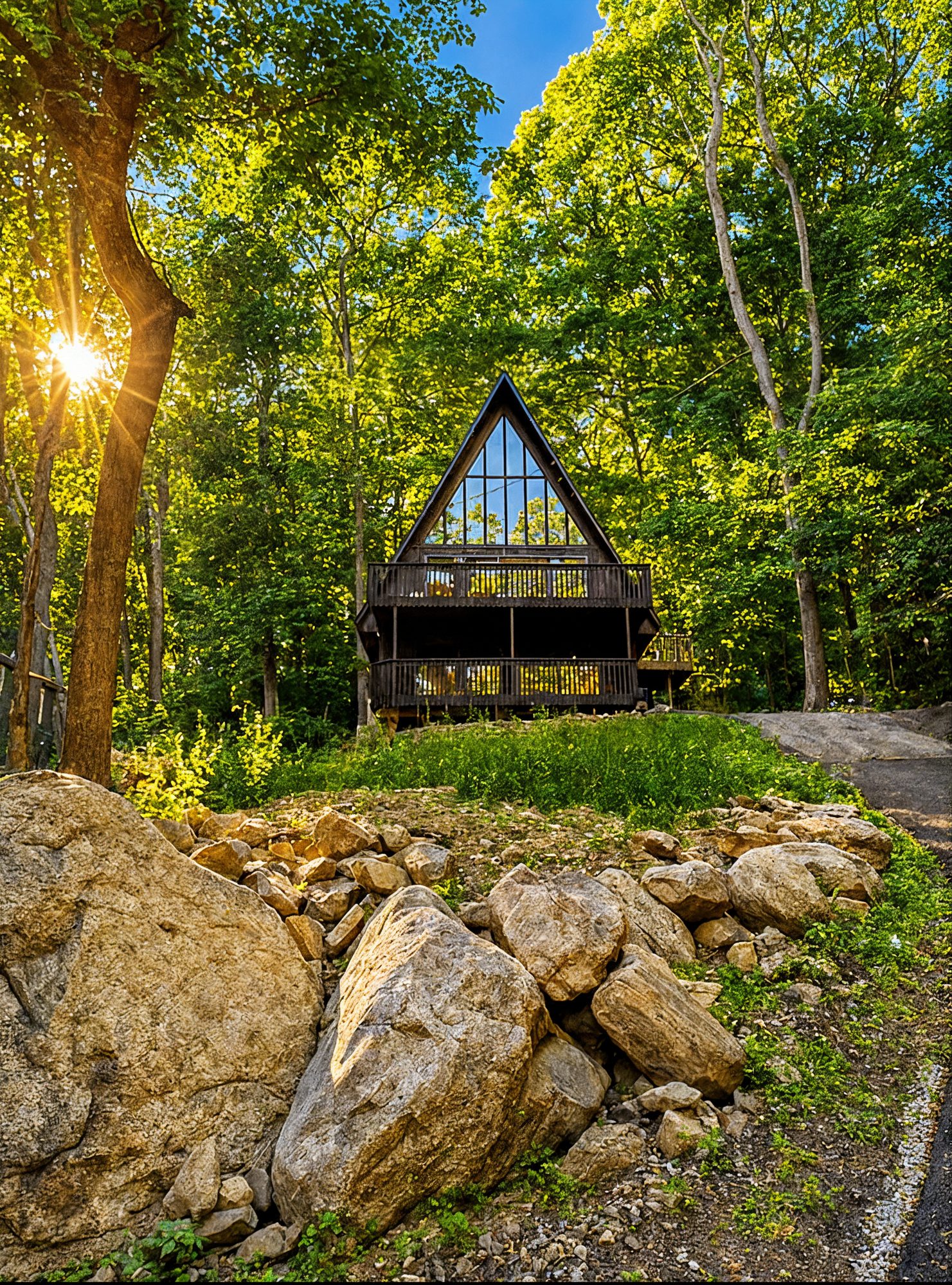 The renovated black A-frame today, golden light through the trees